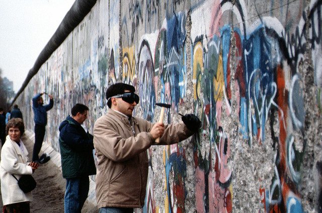Image, people chipping wall. 