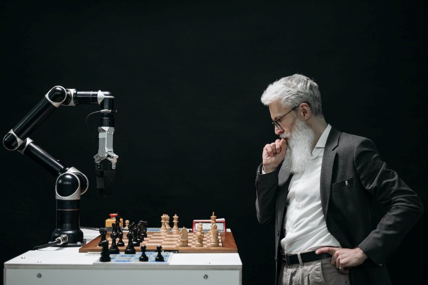 Man playing chess against a machine.