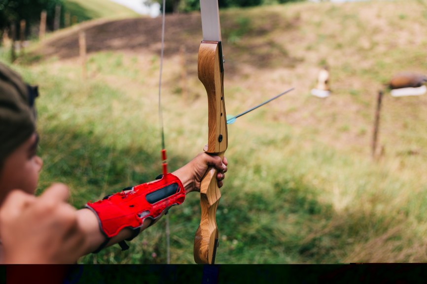 Photo of archer firing an arrow. 