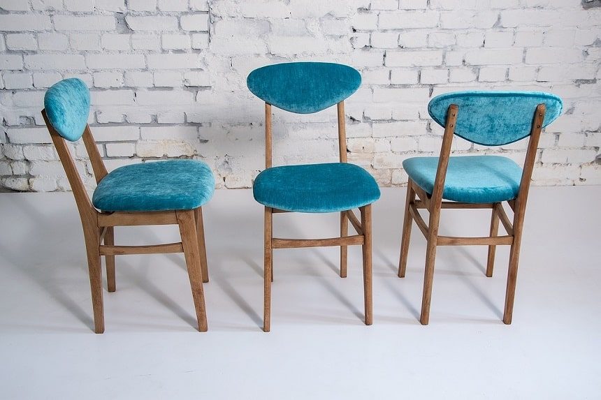 Image, pale blue chairs against a grey wall