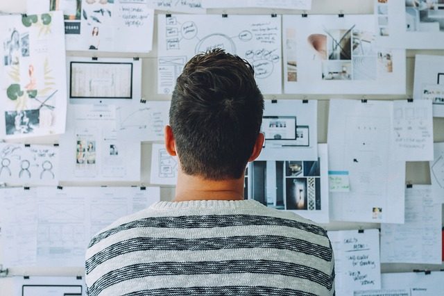 Image, person looking at a story board