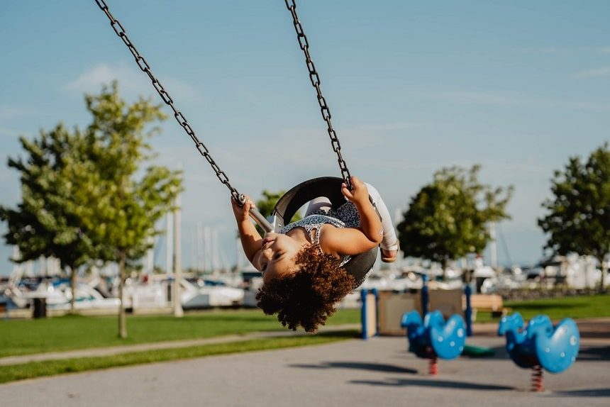 Child playing on a swing in a playground