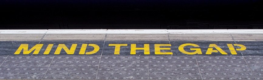 Image, mind the gap warning sign in the London Underground.