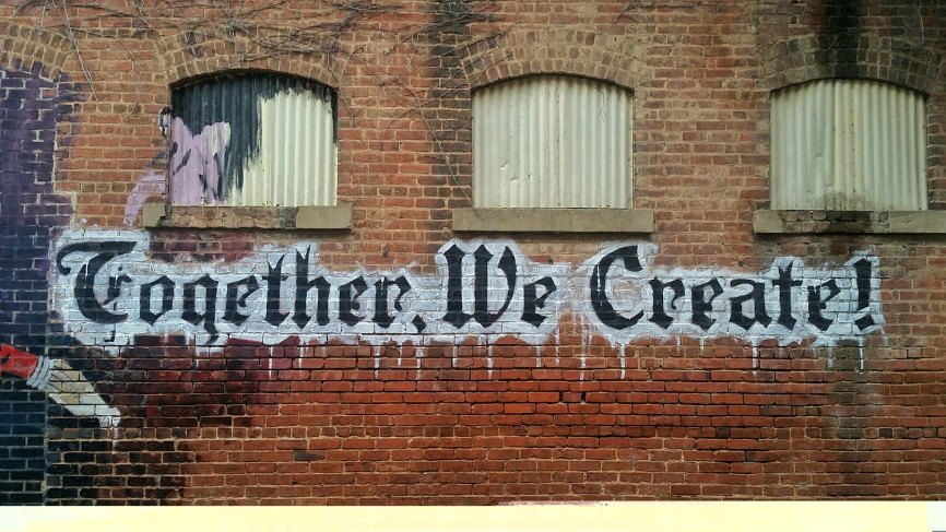Image, Wall with 'Together we create' written on it.