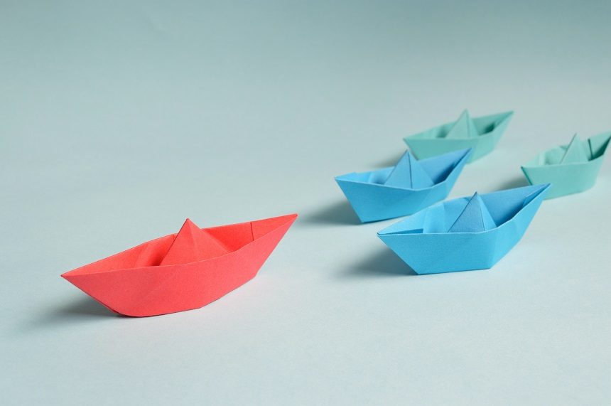 Image, multicoloured origami boats on a table
