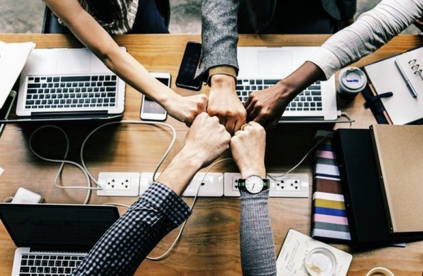 Image, group of hands doing a fist bump.