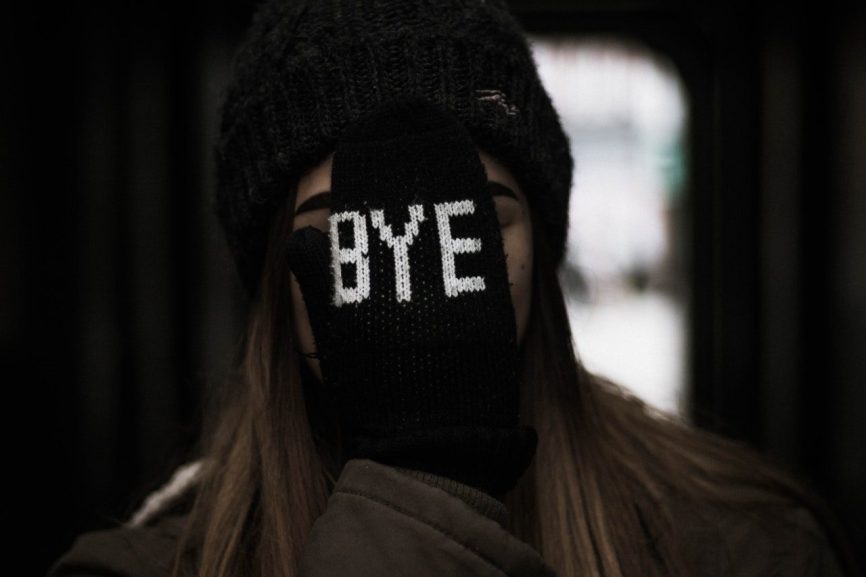 Image, glove with bye text over face.