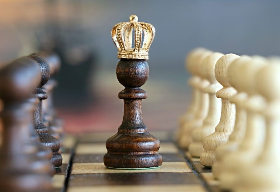 Queen chess piece with golden crown.