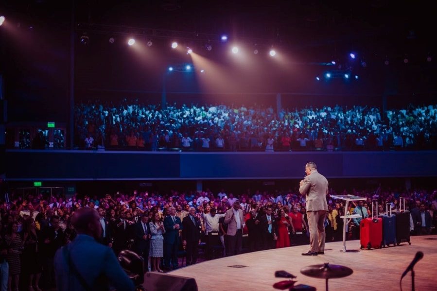 Man presenting on a stage in front of an audience