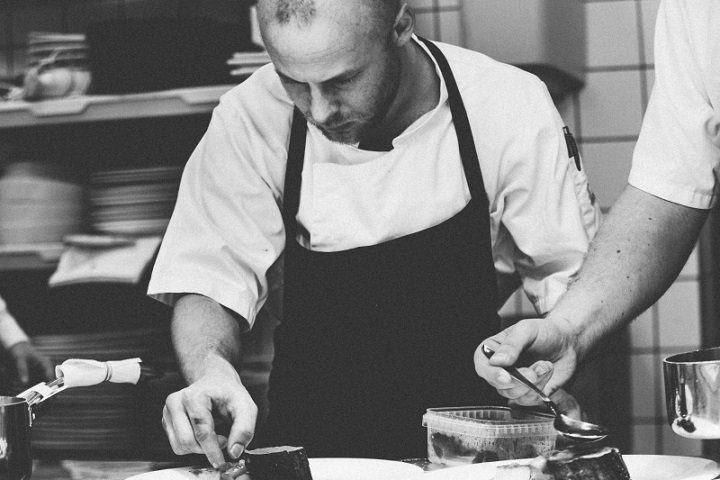 Image, chef carefully plating a fine dining meal.