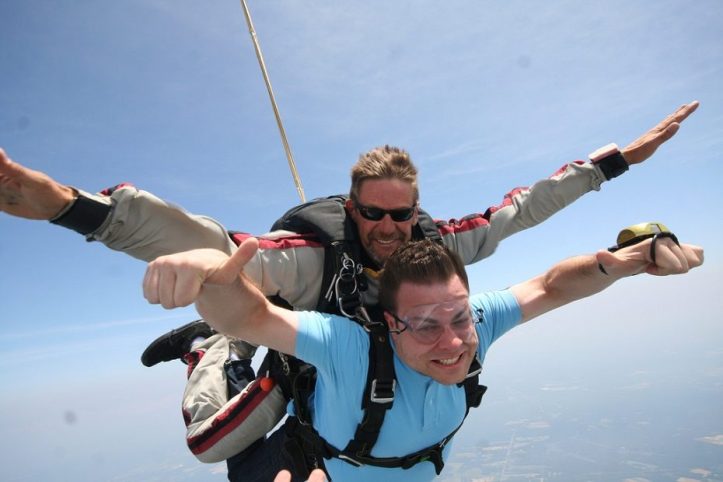 Image, Man skydiving, looking happy.