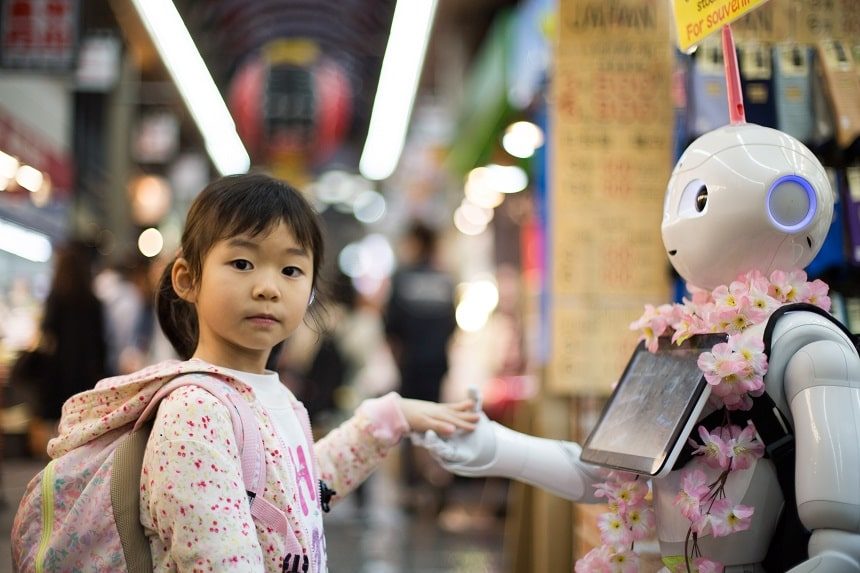 Image, small child holding hands with a toy robot
