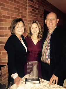 Susan Kleimann, Lynda Harris and Neil James celebrate after the announcement. 