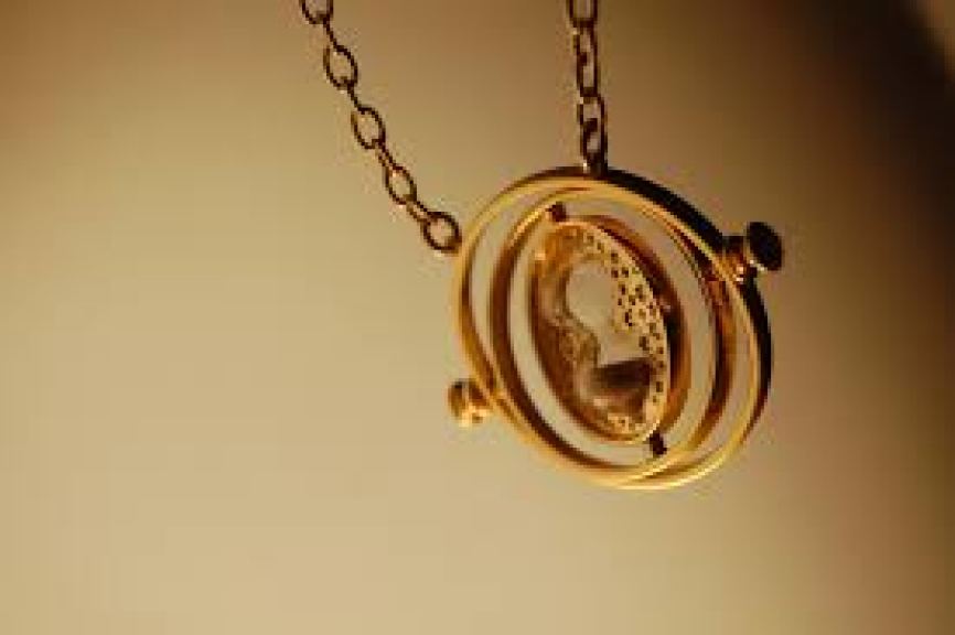 Photo of a Time-Turner - an intricate gold pendant on a chain.