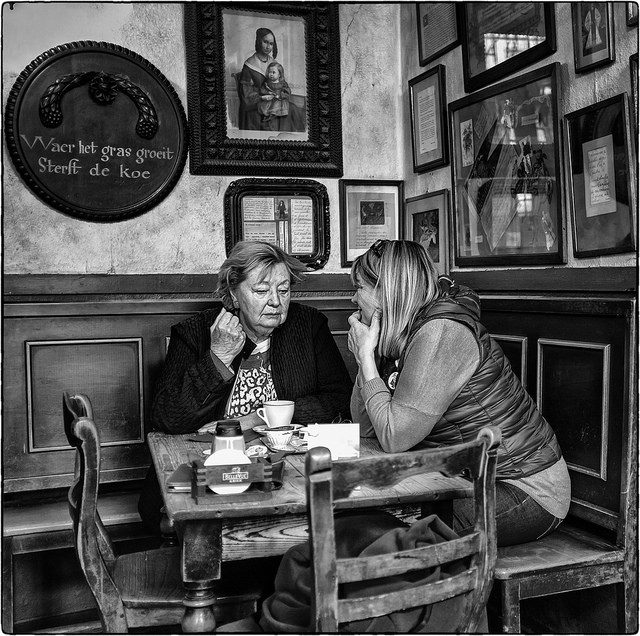 Image, two women gossiping in a cafe.