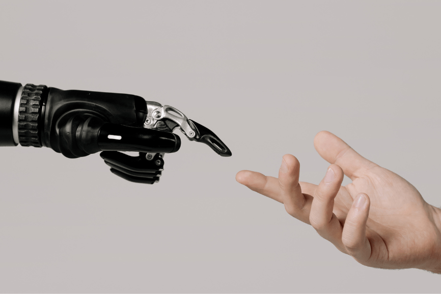 Bionic hand and human hand touching at the fingertips